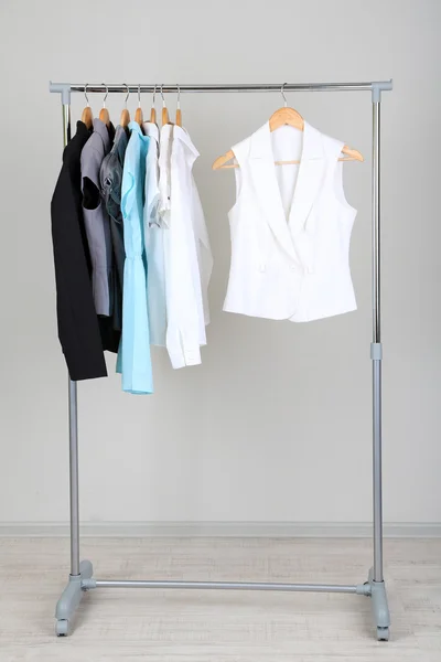 Office clothes on hangers, on gray background — Stock Photo, Image