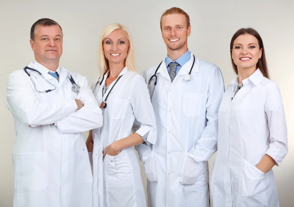 Medical workers on grey background — Stock Photo, Image