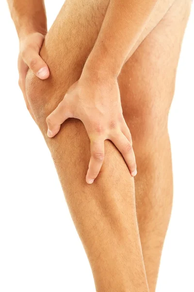 Young man with leg pain, isolated on white — Stock Photo, Image