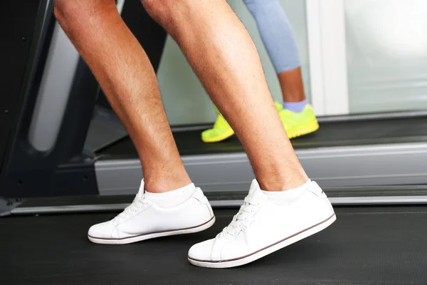 Women and men feet on treadmill close-up — Stock Photo, Image