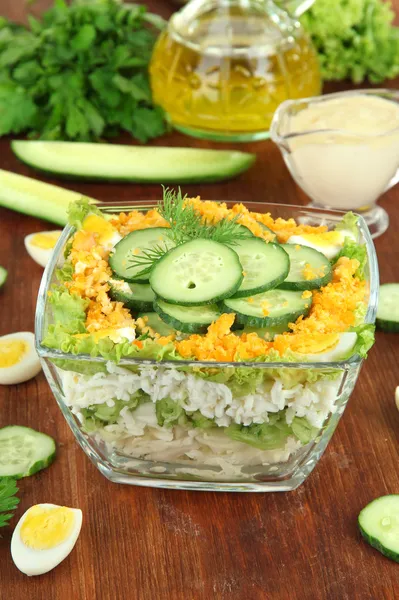 Delicious salad with eggs, cabbage and cucumbers on wooden table — Stock Photo, Image