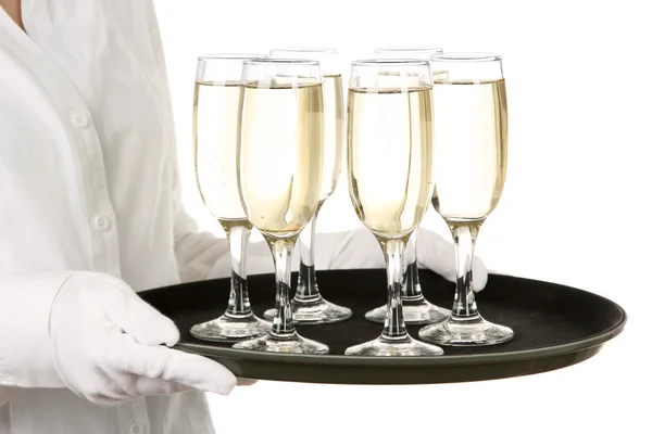 Waitresses holding tray with glasses of champagne, isolated on white — Stock Photo, Image