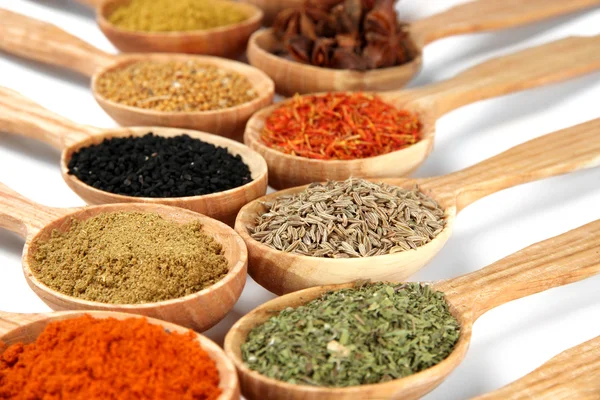 Assortment of spices in wooden spoons — Stock Photo, Image