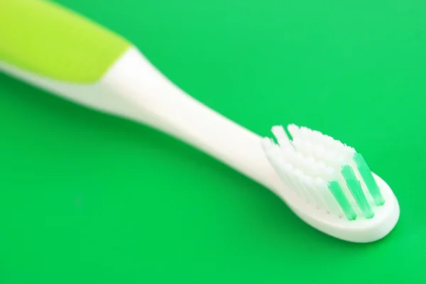 Tooth-brush on green background — Stock Photo, Image