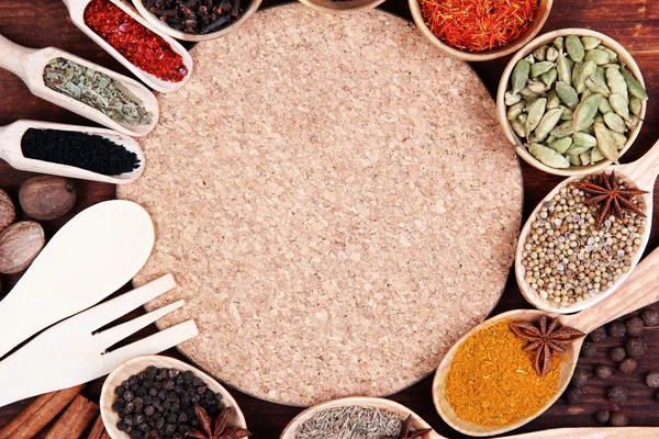 Various spices and herbs with empty board — Stock Photo, Image