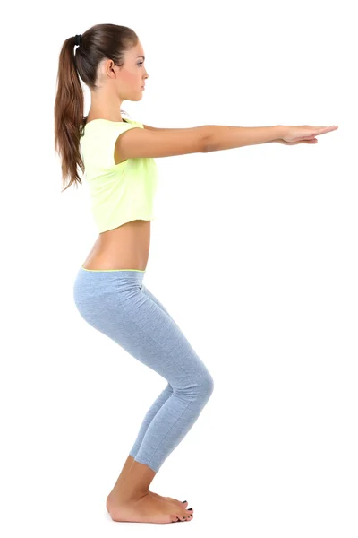 Hermosa joven haciendo ejercicios aislados en blanco — Foto de Stock