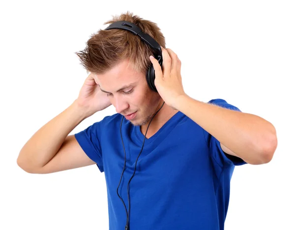 Guapo joven escuchando música aislada en blanco —  Fotos de Stock