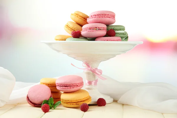 Gentle macaroons in vase on table on light background — Stock Photo, Image