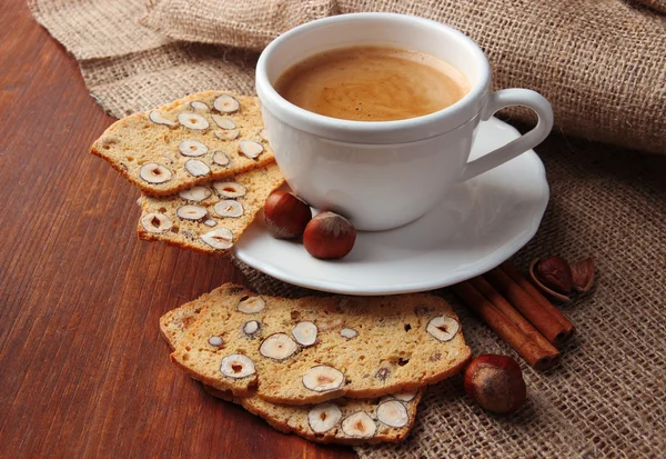 Cup of tasty coffee with Italian biscuit, on wooden background — Stock Photo, Image