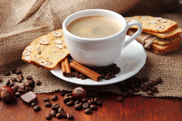 Cup of tasty coffee with tasty Italian biscuits, on wooden background — Stock Photo, Image