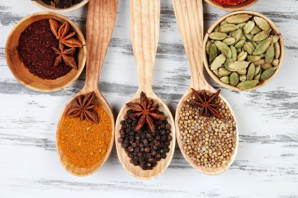 Various spices and herbs on wooden background — Stock Photo, Image