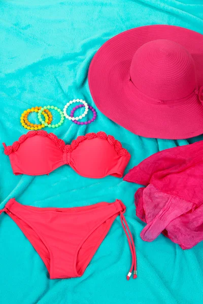 Swimsuit and beach items on bright blue background — Stock Photo, Image