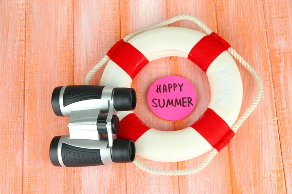 Lifebuoy on color wooden background — Stock Photo, Image