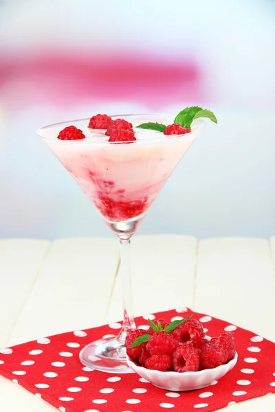 Raspberry milk dessert in cocktail glass, on light background — Stok Foto