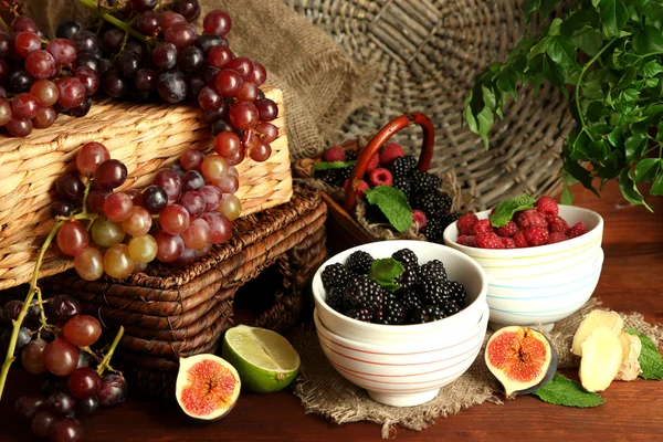 Assortment of juicy fruits and berries on wooden background Royalty Free Stock Images