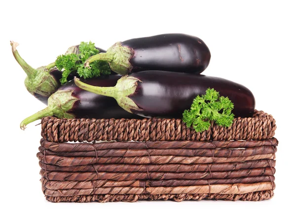 Fresh eggplants in wicker basket isolated on white — Stock Photo, Image