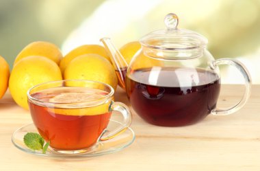 Arka planda limonlu bir fincan çay.