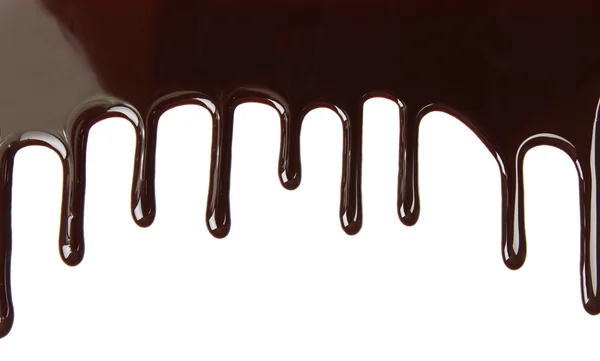 Melted chocolate dripping on white background — Stock Photo, Image