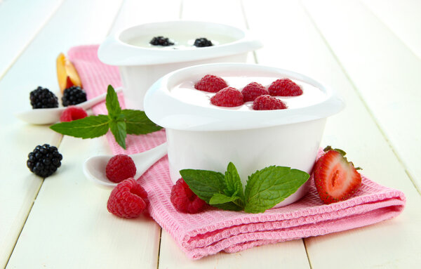 Delicious yogurt with fruit and berries on table close-up