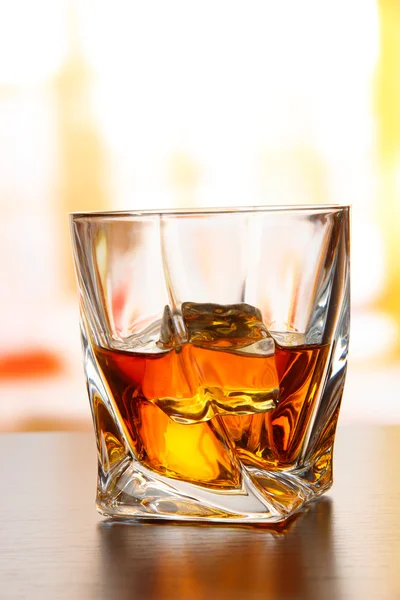 Glass of whiskey, on bright background — Stock Photo, Image