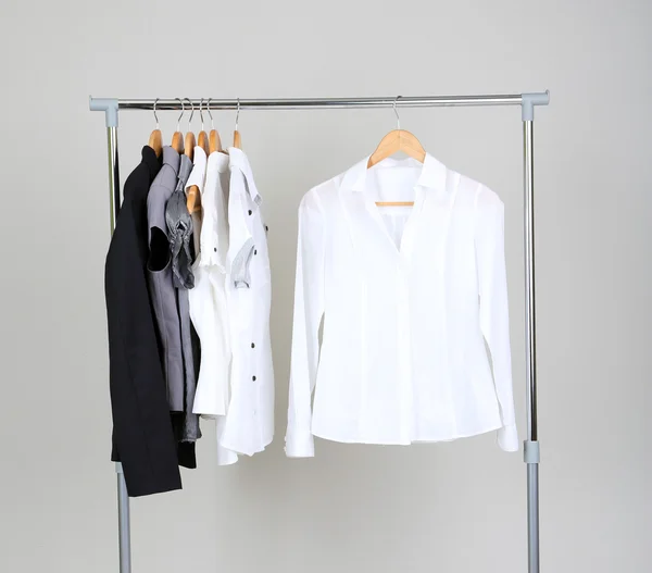 Office clothes on hangers, on gray background — Stock Photo, Image