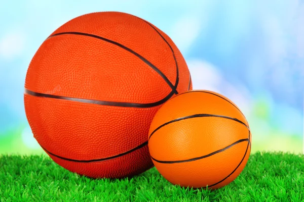 Basket balls, on green grass, on bright background — Stock Photo, Image