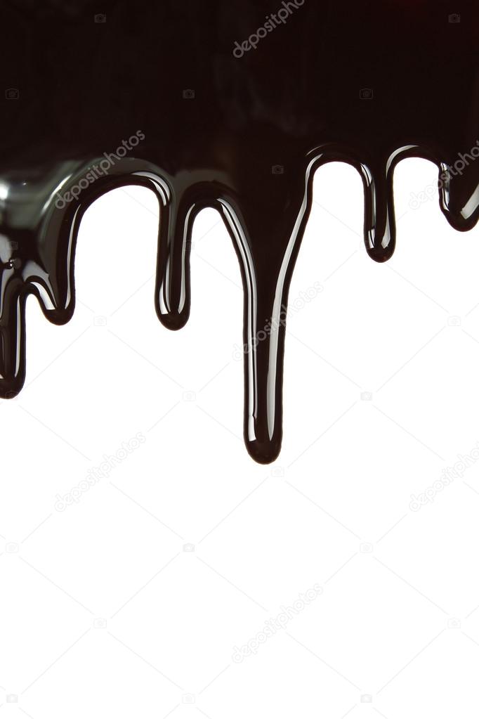 Melted chocolate dripping on white background