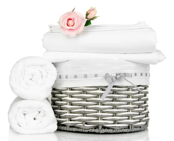 Bedding sheets in wicker basket isolated on white — Stock Photo, Image