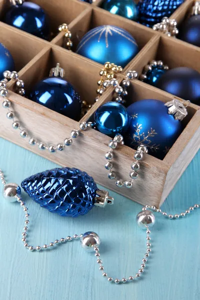 Christmas toys in box on wooden table close-up — Stock Photo, Image