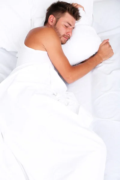 Handsome young man in bed — Stock Photo, Image