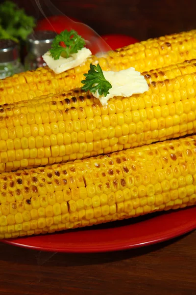 Delicious golden grilled corn with butter on table on wooden background — Stock Photo, Image