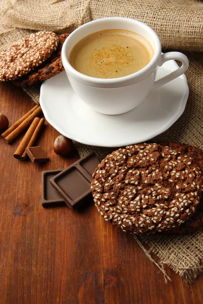 Cup of tasty coffee with tasty cookies, on wooden background — Stock Photo, Image