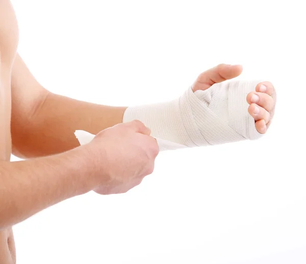 Young man with elastic bandage on hand, isolated on white — Stock Photo, Image