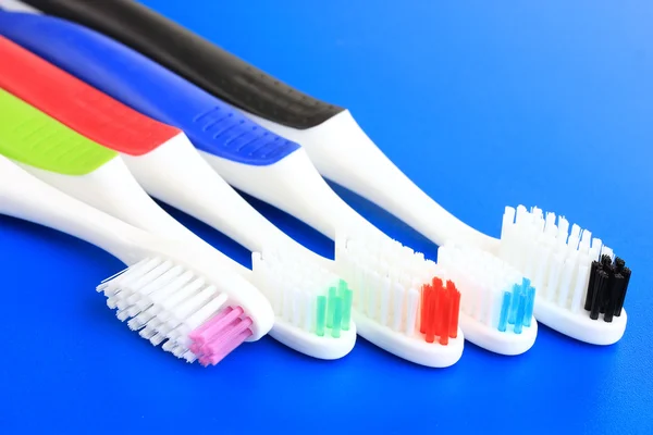 Tooth-brushes on blue background — Stock Photo, Image