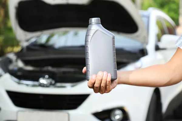 Motor oil in hand — Stock Photo, Image