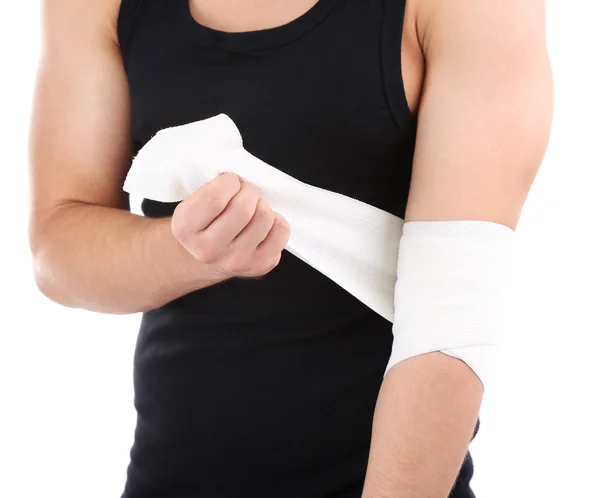 Young man with elastic bandage on hand, isolated on white — Stock Photo, Image