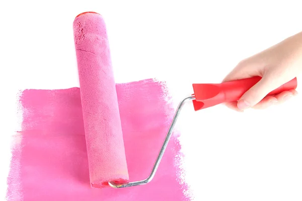 Roller brush with pink paint in hand closeup — Stock Photo, Image