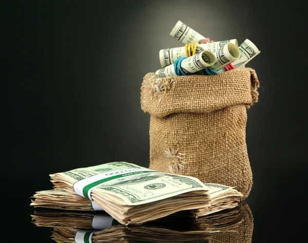 Money in bag on dark color background — Stock Photo, Image