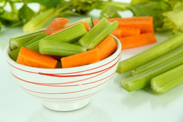 Fresh green celery with vegetables in bowl isolated on white — Stock Photo, Image