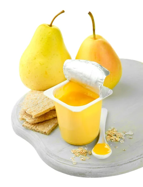 Läckra yoghurt i öppna plastmugg, kakor och frukt, trä ombord, isolerad på vit — Stockfoto