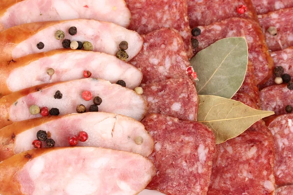Tasty sliced sausage on plate close-up — Stock Photo, Image
