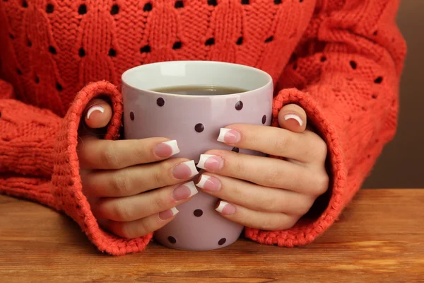 Mains tenant une tasse de boisson chaude, gros plan — Photo