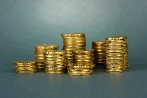 Many coins in columns on grey background — Stock Photo, Image