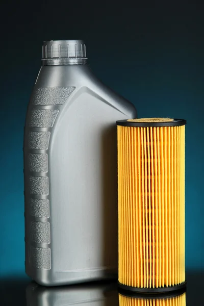 Car oil filters and motor oil can on dark color background