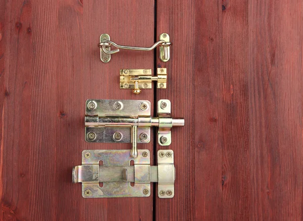 Metal bolts, latches and hooks in wooden door close-up — Stock Photo, Image