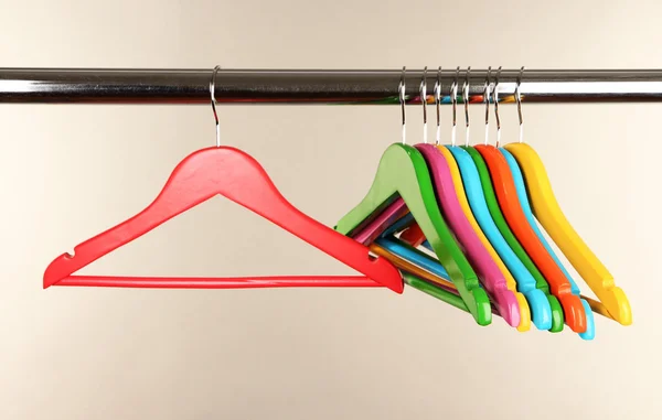 Colorful clothes hangers on gray background — Stock Photo, Image