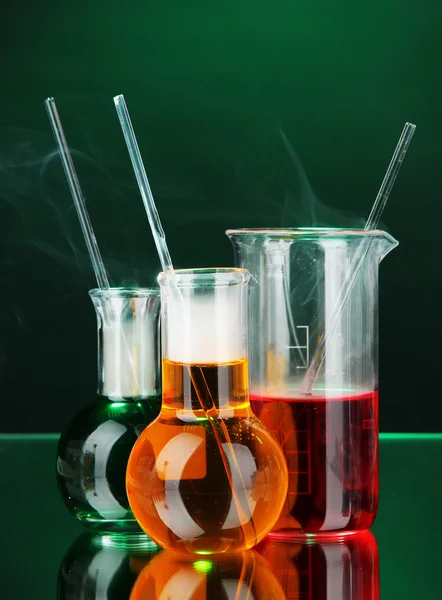 Laboratory glassware on dark color background — Stock Photo, Image