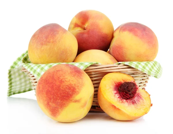 Ripe sweet peaches in wicker basket, isolated on white — Stock Photo, Image