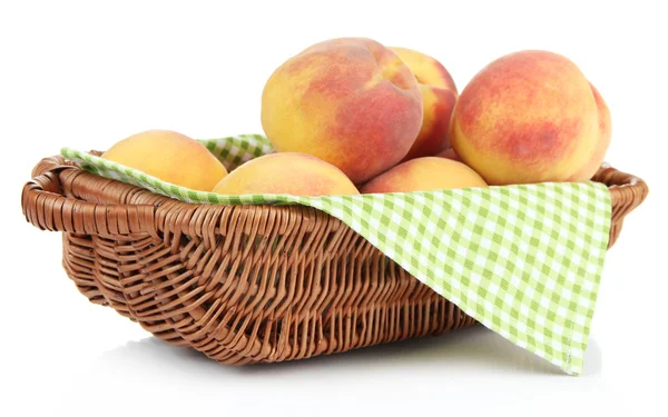 Ripe sweet peaches in wicker basket, isolated on white — Stock Photo, Image