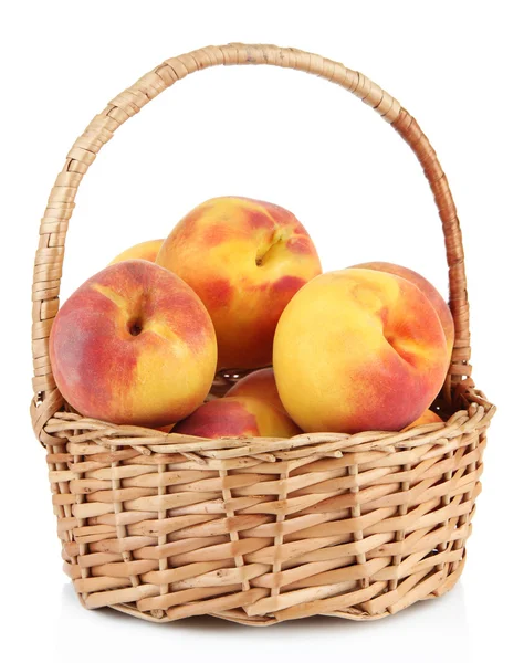 Ripe sweet peaches in wicker basket, isolated on white — Stock Photo, Image